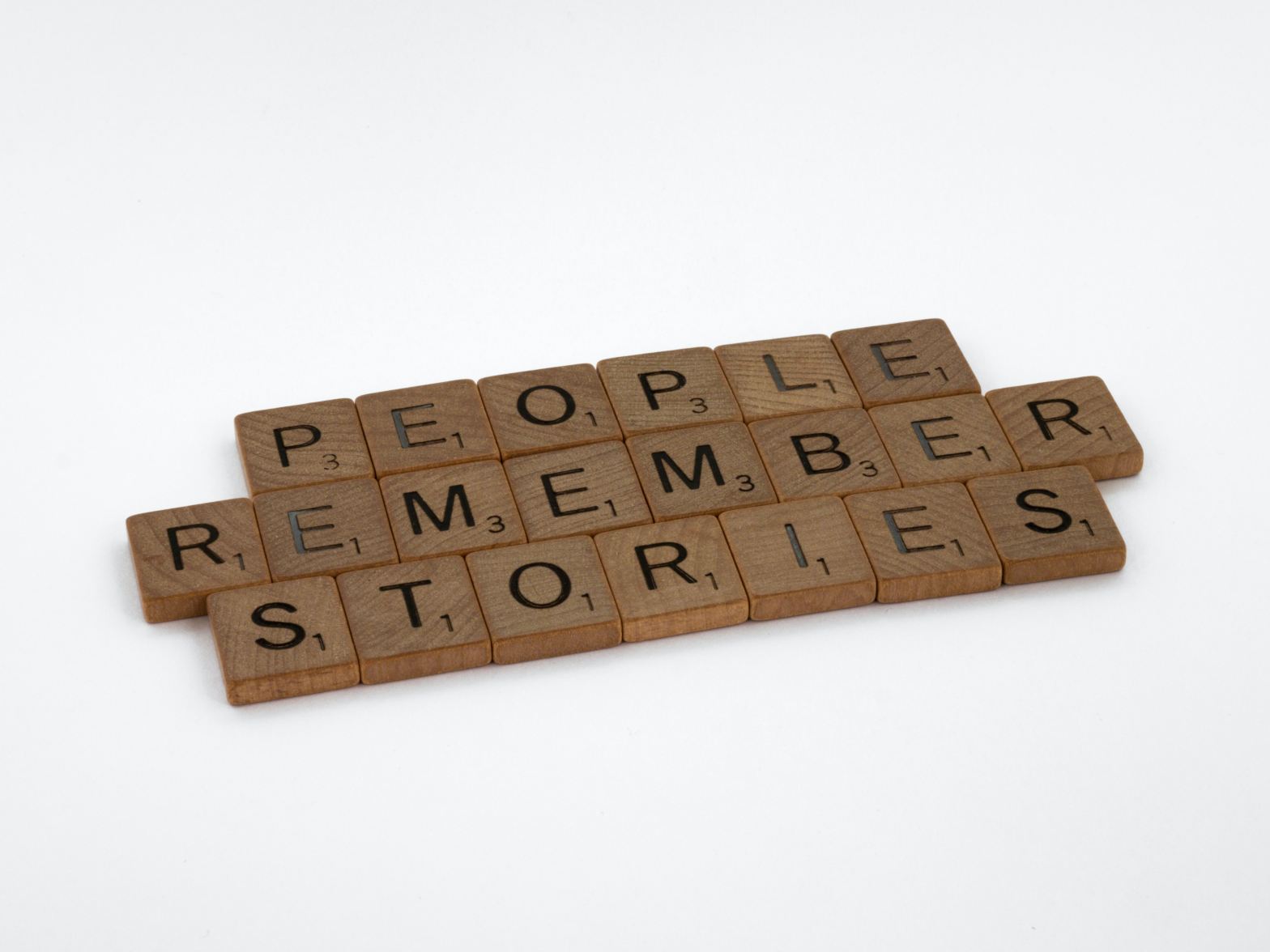 Scrabble blocks saing "people remember stories"